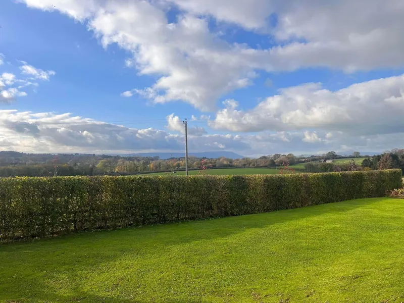 Neatly trimmed garden hedge overlooking the South Wales countryside