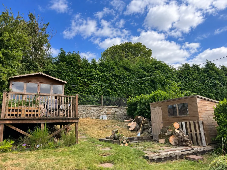 After tree removal: tree safely dismantled beside garden buildings